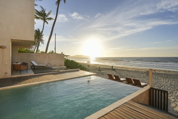 Villa Chukum beachfront pool deck at sunset with the Pacific stretching to the horizon